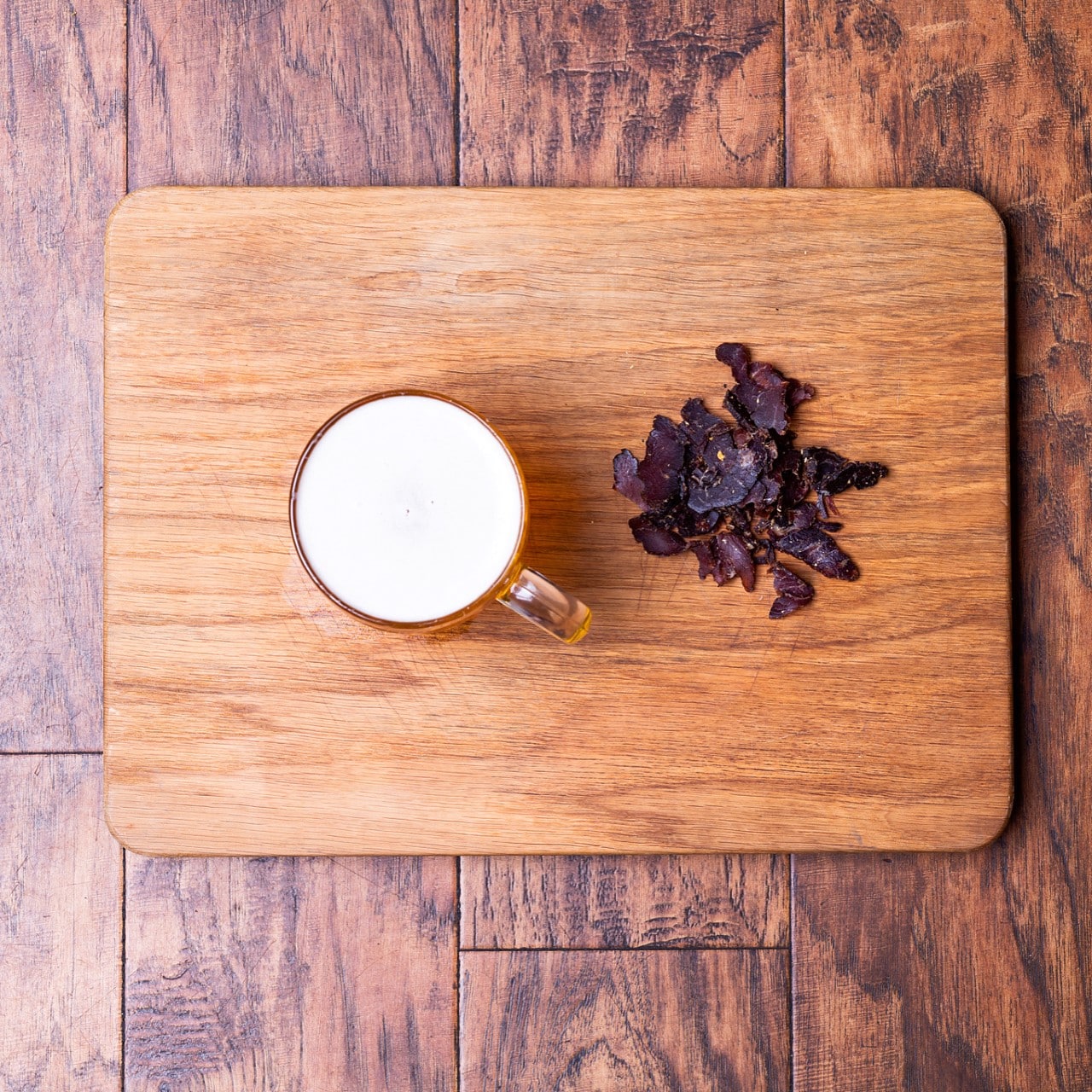 Biltong and drink on wooden chopping board